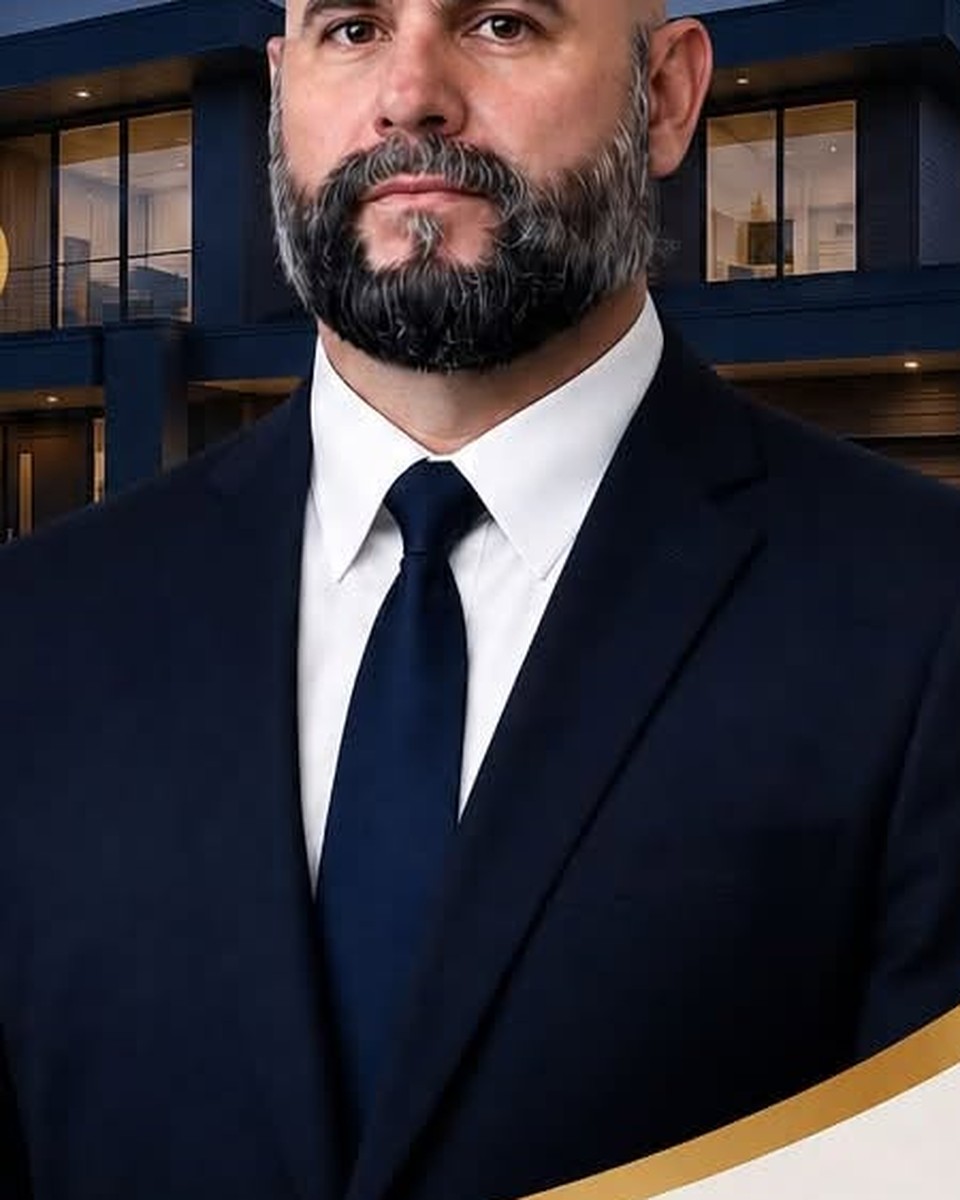 A portrait of Demetrio Ruan, Real Estate Salesperson with Excellence RE Real Estate, in a navy suit